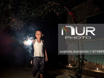 A child plays with light during the 'Deep Utsav or Light festival' before the Diwali festival in Feni, Bangladesh, on October 17, 2024. Diwa...