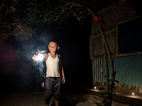 A child plays with light during the 'Deep Utsav or Light festival' before the Diwali festival in Feni, Bangladesh, on October 17, 2024. Diwa...