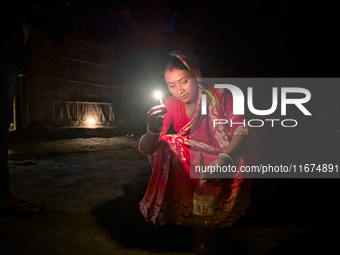 Bangladeshi Hindu people light oil lamps during the 'Deep Utsav or Light festival' before the Diwali festival in Feni, Bangladesh, on Octobe...