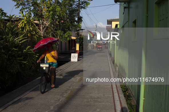 People ride bicycles on the streets of Afua, a city located at the mouth of the Amazon River, where it is forbidden to drive any type of mot...