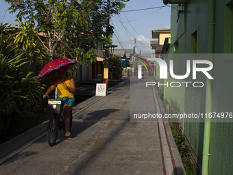 People ride bicycles on the streets of Afua, a city located at the mouth of the Amazon River, where it is forbidden to drive any type of mot...