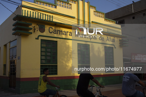 People ride bicycles on the streets of Afua, a city located at the mouth of the Amazon River, where it is forbidden to drive any type of mot...