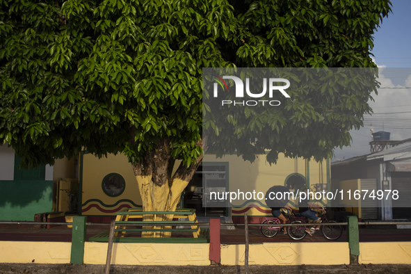 People ride bicycles on the streets of Afua, a city located at the mouth of the Amazon River, where it is forbidden to drive any type of mot...