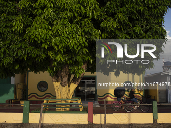 People ride bicycles on the streets of Afua, a city located at the mouth of the Amazon River, where it is forbidden to drive any type of mot...