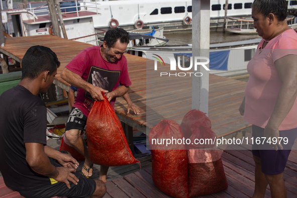 A man arrives with goods at the mouth of the Amazon River in Afua, Para, Brazil, on September 27, 2024. 