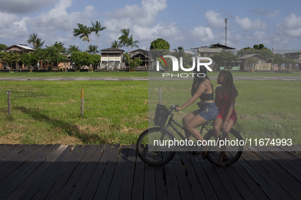 People ride bicycles on stilts in Afua, Para, Brazil, on September 29, 2024. 