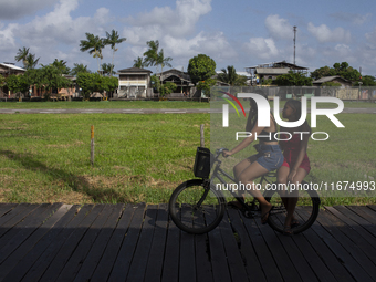 People ride bicycles on stilts in Afua, Para, Brazil, on September 29, 2024. (