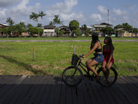 People ride bicycles on stilts in Afua, Para, Brazil, on September 29, 2024. (