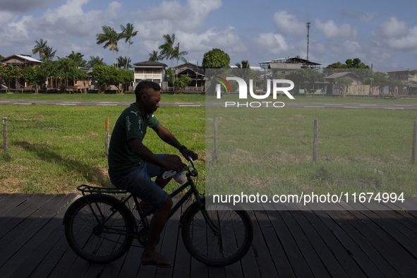 People ride bicycles on stilts in Afua, Para, Brazil, on September 29, 2024. 