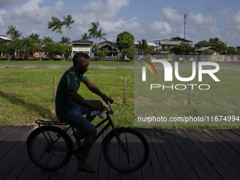 People ride bicycles on stilts in Afua, Para, Brazil, on September 29, 2024. (