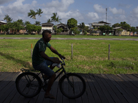 People ride bicycles on stilts in Afua, Para, Brazil, on September 29, 2024. (