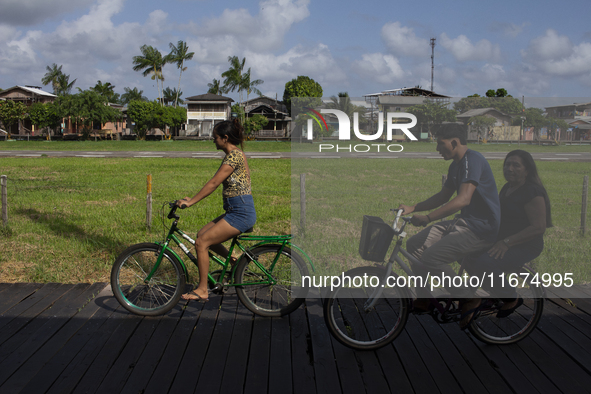 People ride bicycles on stilts in Afua, Para, Brazil, on September 29, 2024. 