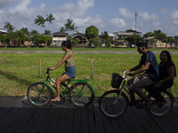 People ride bicycles on stilts in Afua, Para, Brazil, on September 29, 2024. (