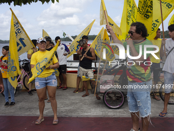 Supporters of Afua mayoral candidate Sandro Cunha walk in Afua, Para, Brazil, on September 29, 2024. (