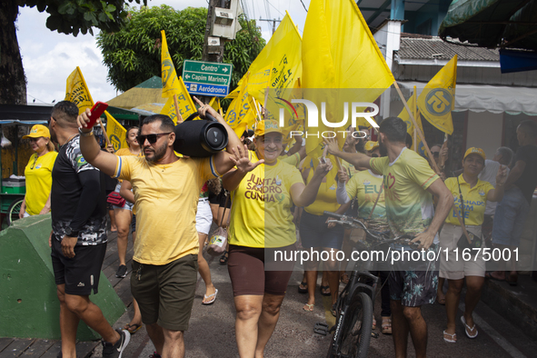 Supporters of Afua mayoral candidate Sandro Cunha walk in Afua, Para, Brazil, on September 29, 2024. 