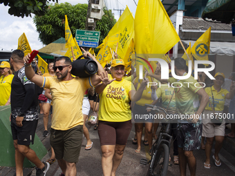 Supporters of Afua mayoral candidate Sandro Cunha walk in Afua, Para, Brazil, on September 29, 2024. (