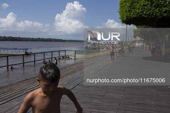 Children play at the municipal spa located at the mouth of the Amazon River in Afua, Para, Brazil, on September 29, 2024. 