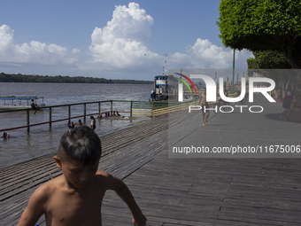 Children play at the municipal spa located at the mouth of the Amazon River in Afua, Para, Brazil, on September 29, 2024. (