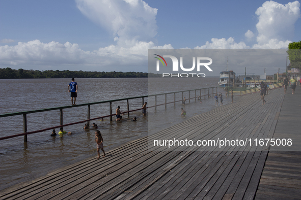 Children play at the municipal spa located at the mouth of the Amazon River in Afua, Para, Brazil, on September 29, 2024. 