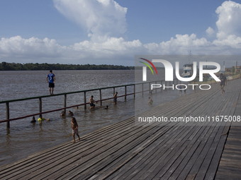 Children play at the municipal spa located at the mouth of the Amazon River in Afua, Para, Brazil, on September 29, 2024. (