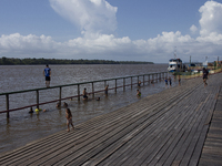 Children play at the municipal spa located at the mouth of the Amazon River in Afua, Para, Brazil, on September 29, 2024. (