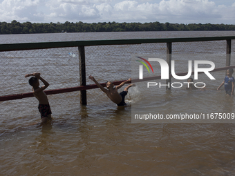 Children play at the municipal spa located at the mouth of the Amazon River in Afua, Para, Brazil, on September 29, 2024. (