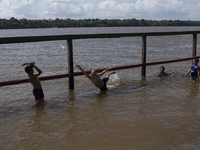 Children play at the municipal spa located at the mouth of the Amazon River in Afua, Para, Brazil, on September 29, 2024. (