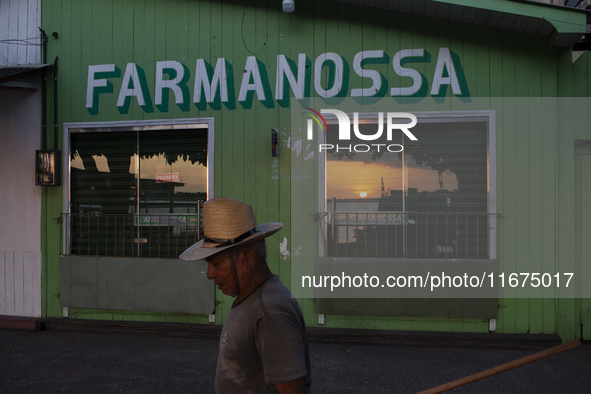 A man wearing a hat walks during the evening in Afua, Para, Brazil, on September 29, 2024. 