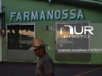 A man wearing a hat walks during the evening in Afua, Para, Brazil, on September 29, 2024. (