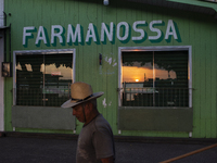 A man wearing a hat walks during the evening in Afua, Para, Brazil, on September 29, 2024. (