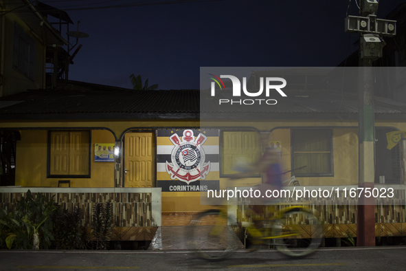 A man rides a bicycle in Afua, Para, Brazil, on September 29, 2024. 