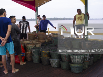 Acai fruit traders, known as the black gold of the Amazon, are at the municipal market in Afua, Para, Brazil, on September 30, 2024. (