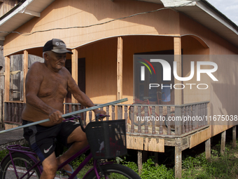 A man rides a bicycle in the streets of the city known as the city of bicycles in Afua, Para, Brazil, on September 30, 2024. (