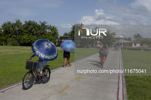 People ride bicycles in the streets of the city known as the city of bicycles, located at the mouth of the Amazon River, in Afua, Para, Braz...