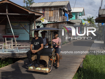 People ride bicycles in the streets of the city known as the city of bicycles, located at the mouth of the Amazon River, in Afua, Para, Braz...