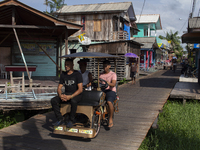 People ride bicycles in the streets of the city known as the city of bicycles, located at the mouth of the Amazon River, in Afua, Para, Braz...