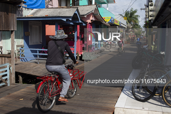 People ride bicycles in the streets of the city known as the city of bicycles, located at the mouth of the Amazon River, in Afua, Para, Braz...