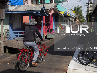 People ride bicycles in the streets of the city known as the city of bicycles, located at the mouth of the Amazon River, in Afua, Para, Braz...