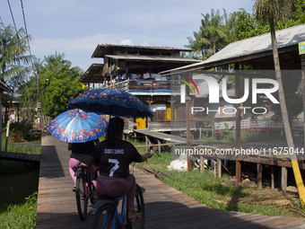 People ride bicycles in the streets of the city known as the city of bicycles, located at the mouth of the Amazon River, in Afua, Para, Braz...