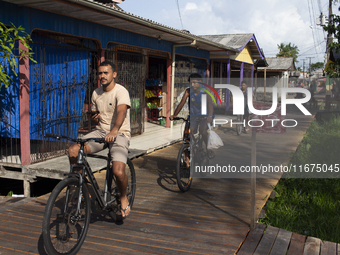 People ride bicycles in the streets of the city known as the city of bicycles, located at the mouth of the Amazon River, in Afua, Para, Braz...