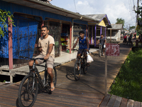 People ride bicycles in the streets of the city known as the city of bicycles, located at the mouth of the Amazon River, in Afua, Para, Braz...