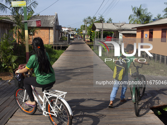 People ride bicycles in the streets of the city known as the city of bicycles, located at the mouth of the Amazon River, in Afua, Para, Braz...