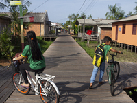 People ride bicycles in the streets of the city known as the city of bicycles, located at the mouth of the Amazon River, in Afua, Para, Braz...