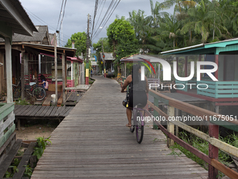 People ride bicycles in the streets of the city known as the city of bicycles, located at the mouth of the Amazon River, in Afua, Para, Braz...