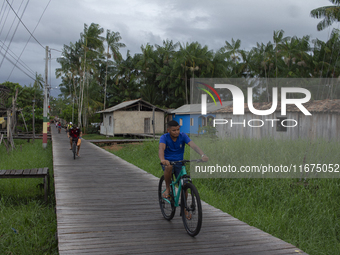 People ride bicycles in the streets of the city known as the city of bicycles, located at the mouth of the Amazon River, in Afua, Para, Braz...