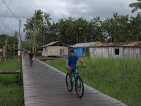 People ride bicycles in the streets of the city known as the city of bicycles, located at the mouth of the Amazon River, in Afua, Para, Braz...