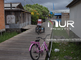 People ride bicycles in the streets of the city known as the city of bicycles, located at the mouth of the Amazon River, in Afua, Para, Braz...