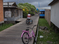 People ride bicycles in the streets of the city known as the city of bicycles, located at the mouth of the Amazon River, in Afua, Para, Braz...