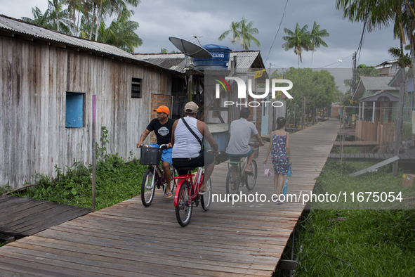 People ride bicycles in the streets of the city known as the city of bicycles, located at the mouth of the Amazon River, in Afua, Para, Braz...