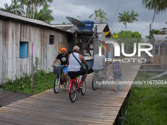 People ride bicycles in the streets of the city known as the city of bicycles, located at the mouth of the Amazon River, in Afua, Para, Braz...